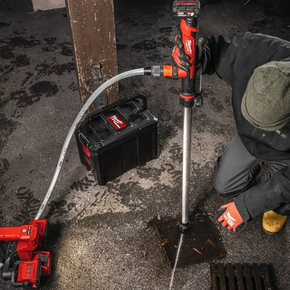 The M12™ HYDROPASS™ M12-BSWP water pump actively pumping water from a flooded trench, demonstrating its effectiveness in draining large volumes.